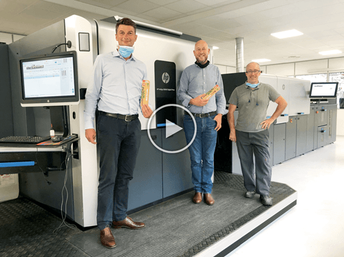 Gaultier employees standing in front of a machine holding packaging