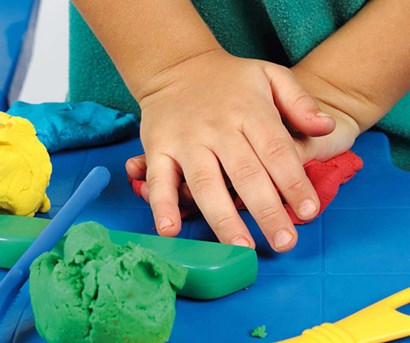 Kid playing with play dough